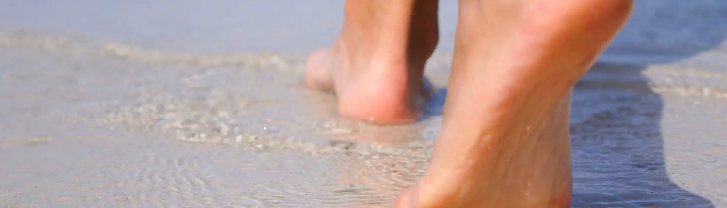 Feet walking on the beach